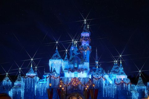 Disneyland castle in Anaheim, California — Sleeping Beauty Castle illuminated at dusk against a Southern California sky
