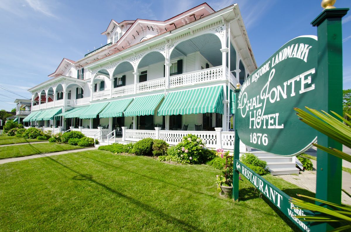 Cape May New Jersey — Victorian gingerbread architecture along Beach Avenue, pastel painted houses with wraparound porches and ocean beyond