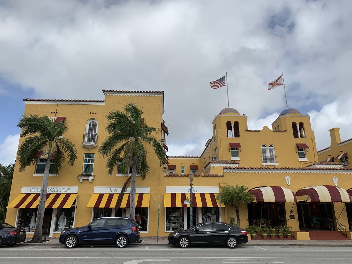 Delray Beach Atlantic Avenue and Florida coastline — palm trees, restaurants, boutique storefronts under late afternoon sun