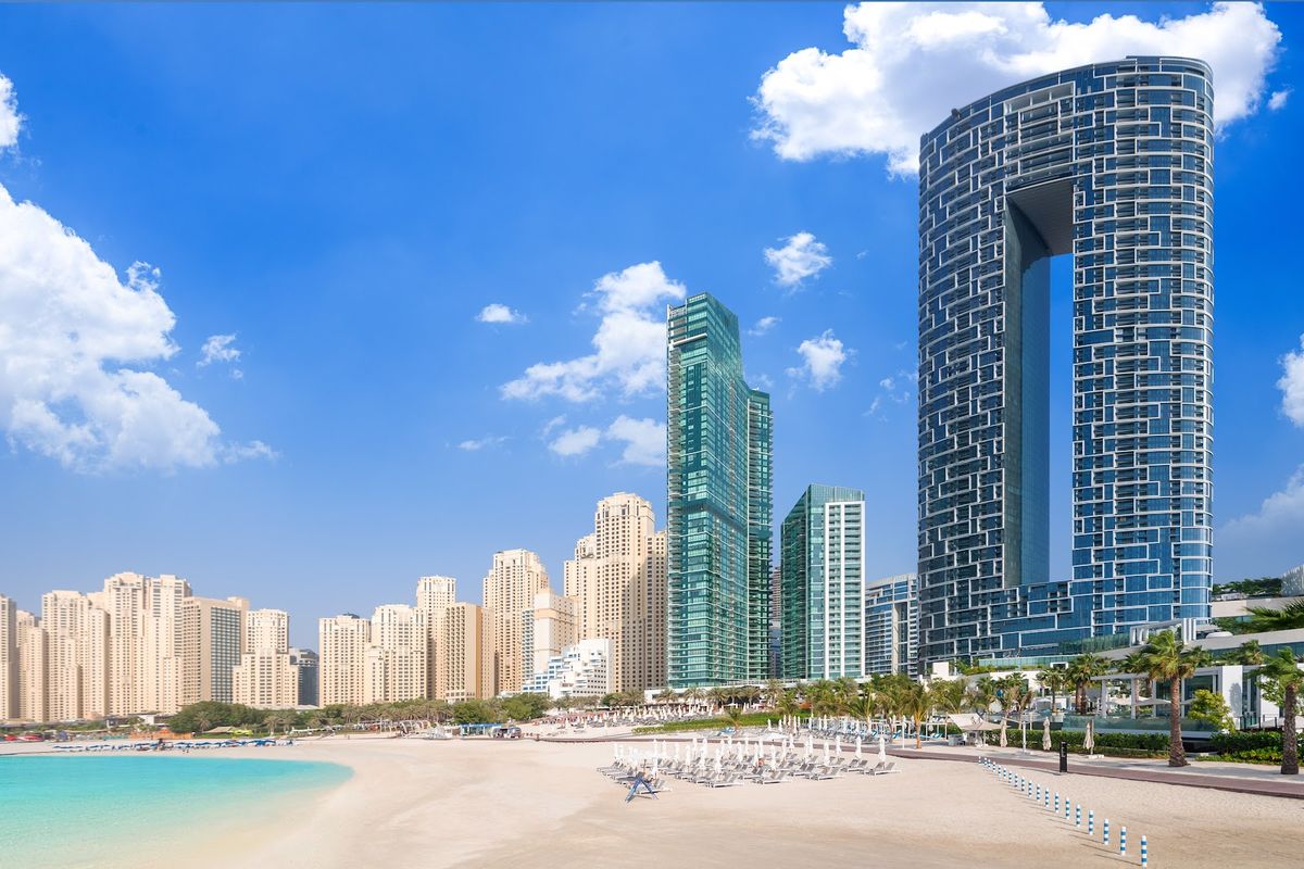Dubai skyline at twilight — Burj Khalifa, Marina towers, and Palm Jumeirah, the world's most ambitious hotel city