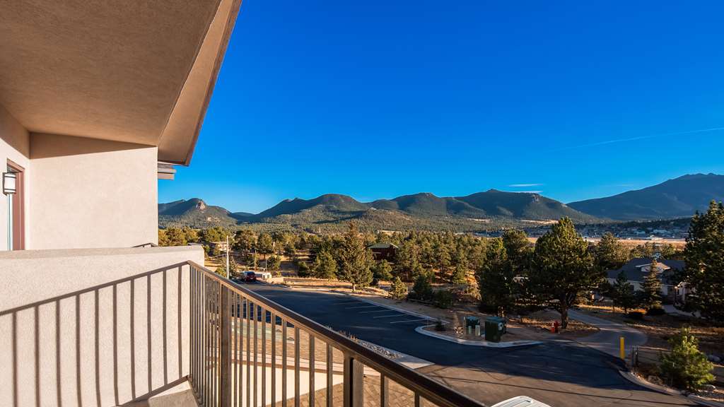 Estes Park, Colorado — Rocky Mountain National Park peaks above an alpine valley with a winding river and golden meadows