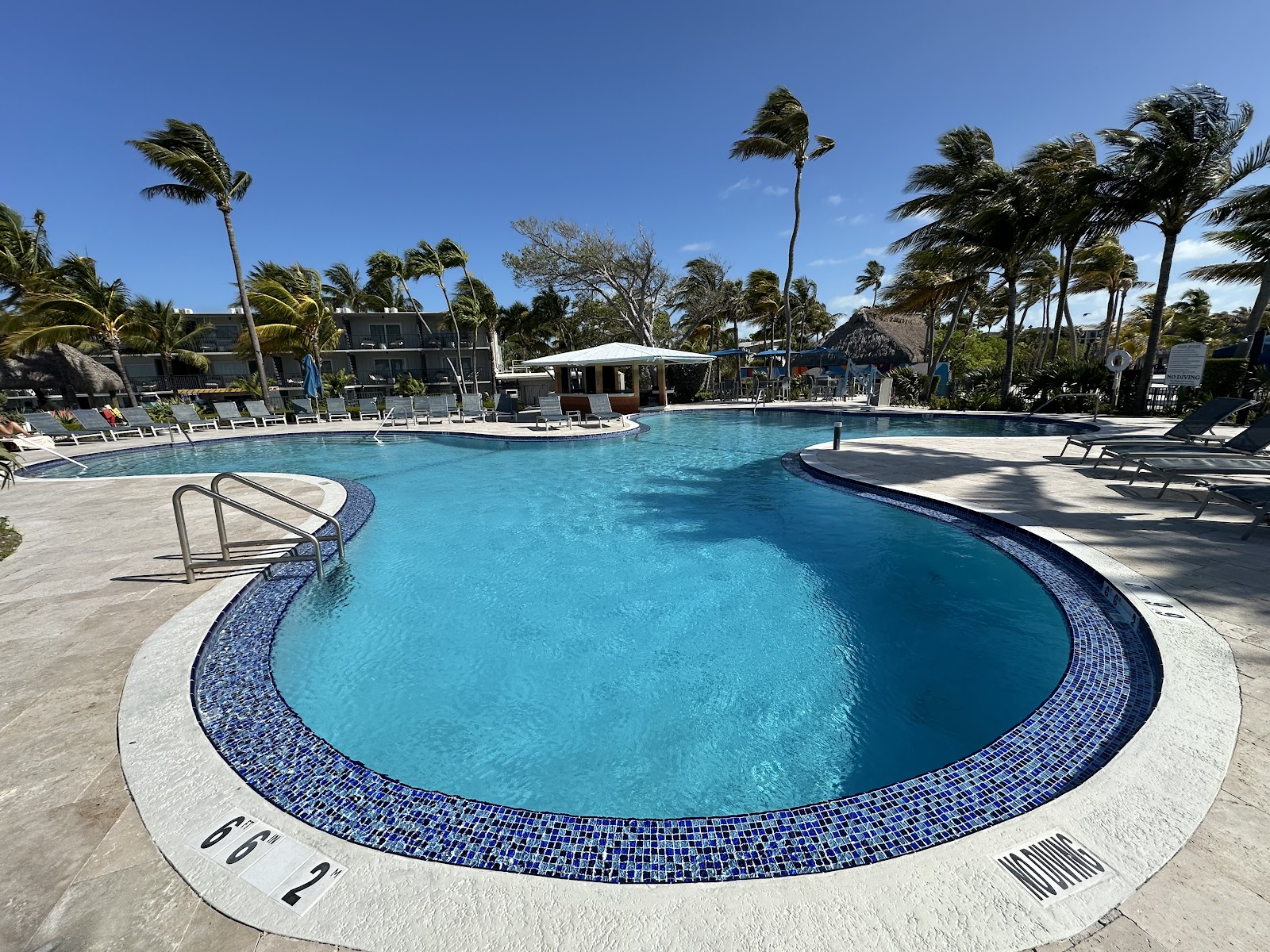 Postcard Inn Beach Resort Islamorada — Atlantic pier and oceanfront cabanas at Mile Marker 84