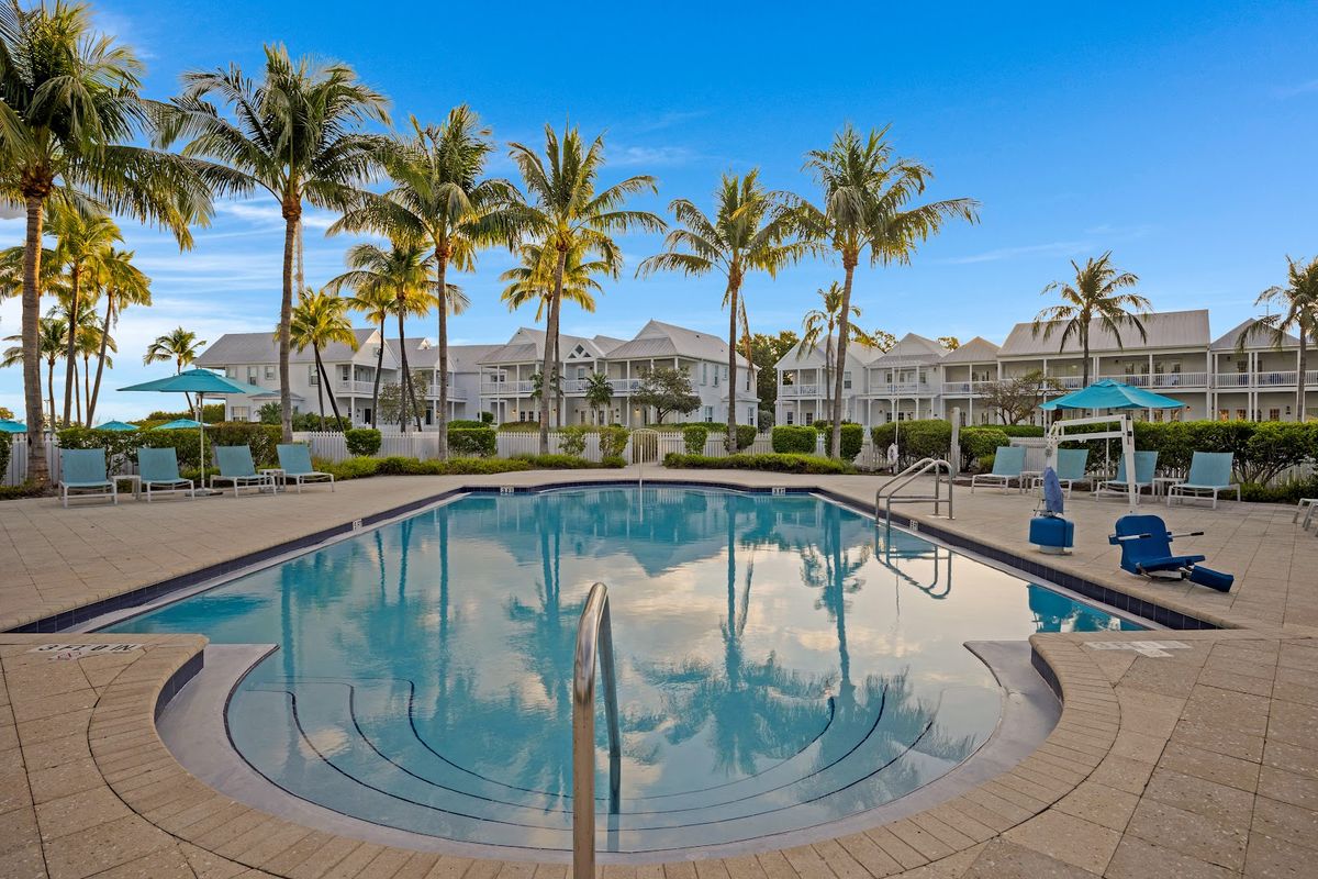 Amara Cay Resort Islamorada — oceanfront pool with palm trees and tiki bar overlooking Atlantic flats