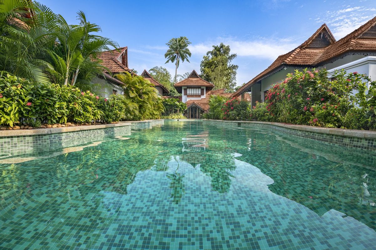 Kerala India — backwater houseboat in Alleppey lagoons with palm trees, southern India spice coast