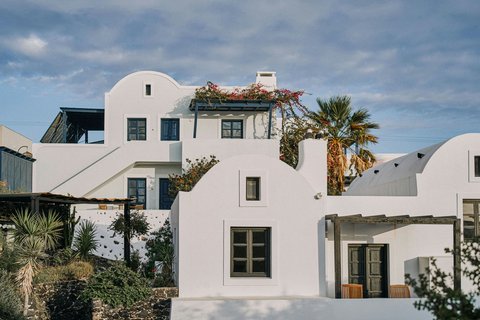 Mystique Luxury Collection Hotel Santorini — cave rooms on Oia caldera cliff with private pools and Aegean panorama