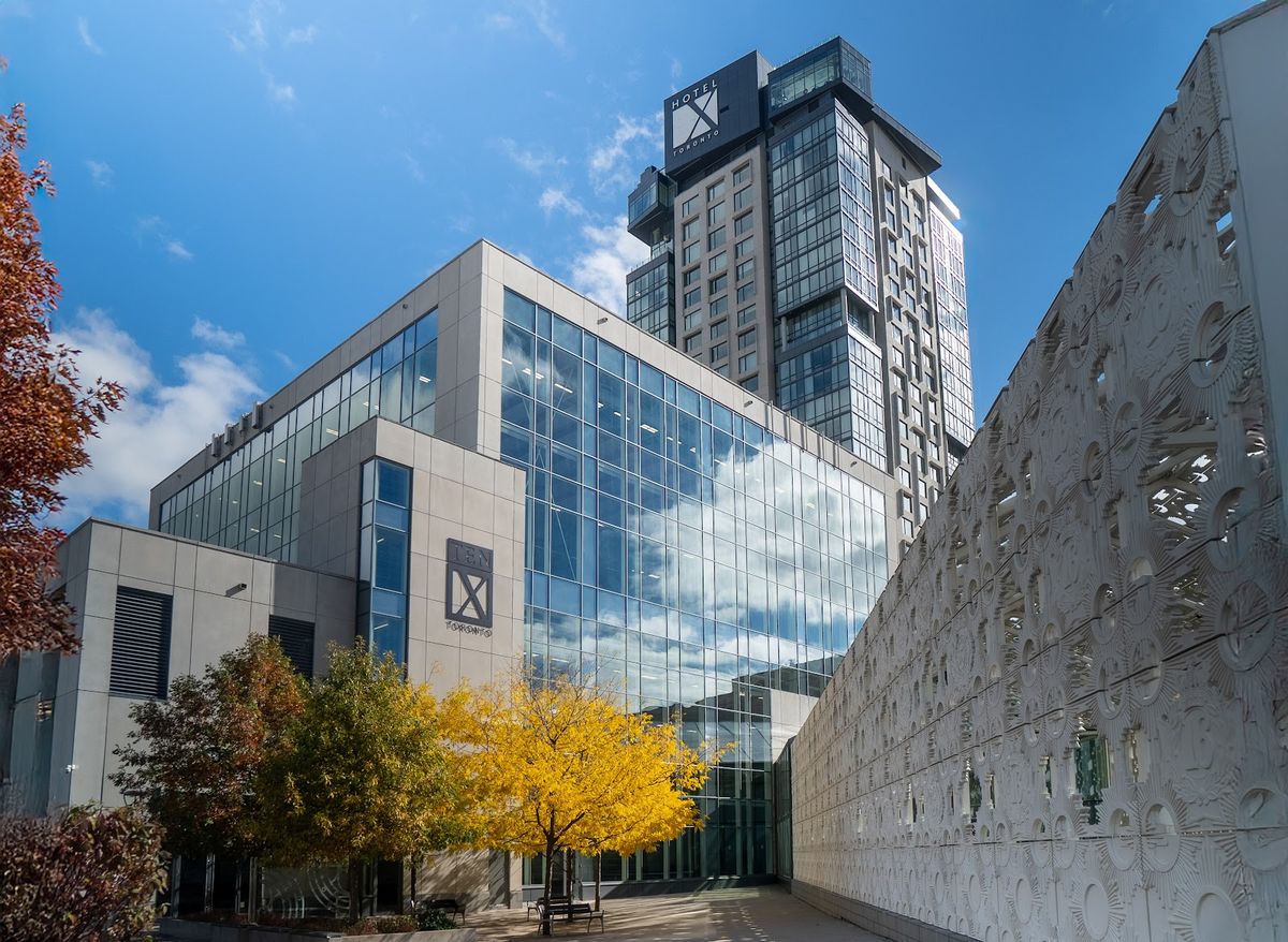 Hotel X Toronto — fourteen-storey lakefront resort hotel at Exhibition Place with Lake Ontario and CN Tower behind