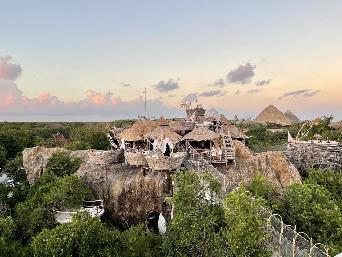 Tulum beach with Mayan ruins on cliff — palm-fringed white sand, Caribbean Sea and Tulum archaeological site, Yucatan Mexico