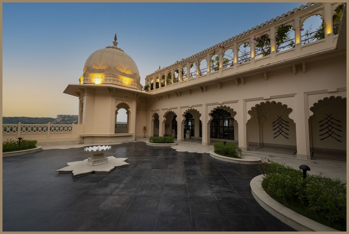 Udaipur Lake Palace floating on Lake Pichola at sunrise — white marble