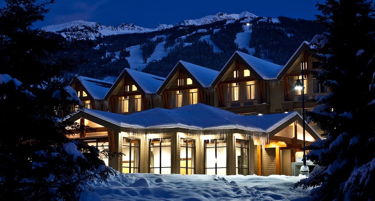 Whistler ski village in winter — Blackcomb and Whistler Mountains rising behind the alpine resort, snow-covered chalets and gondolas